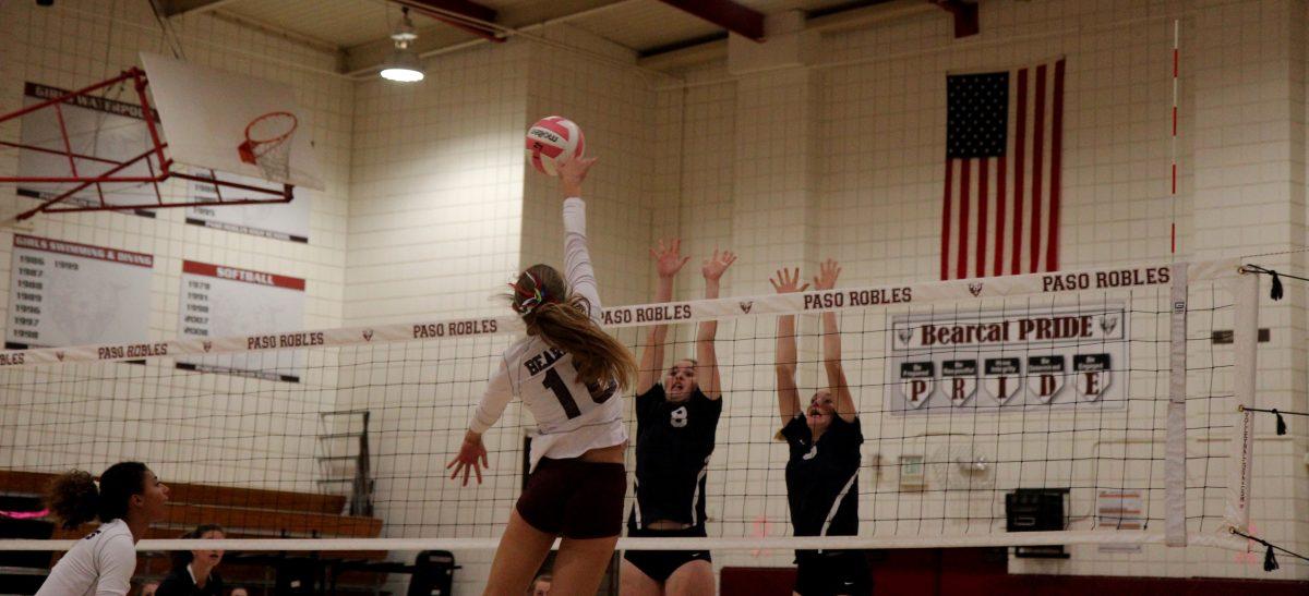 Number 16, Tegan Curren comes above the net to spike down on Arroyo Grandes blockers.