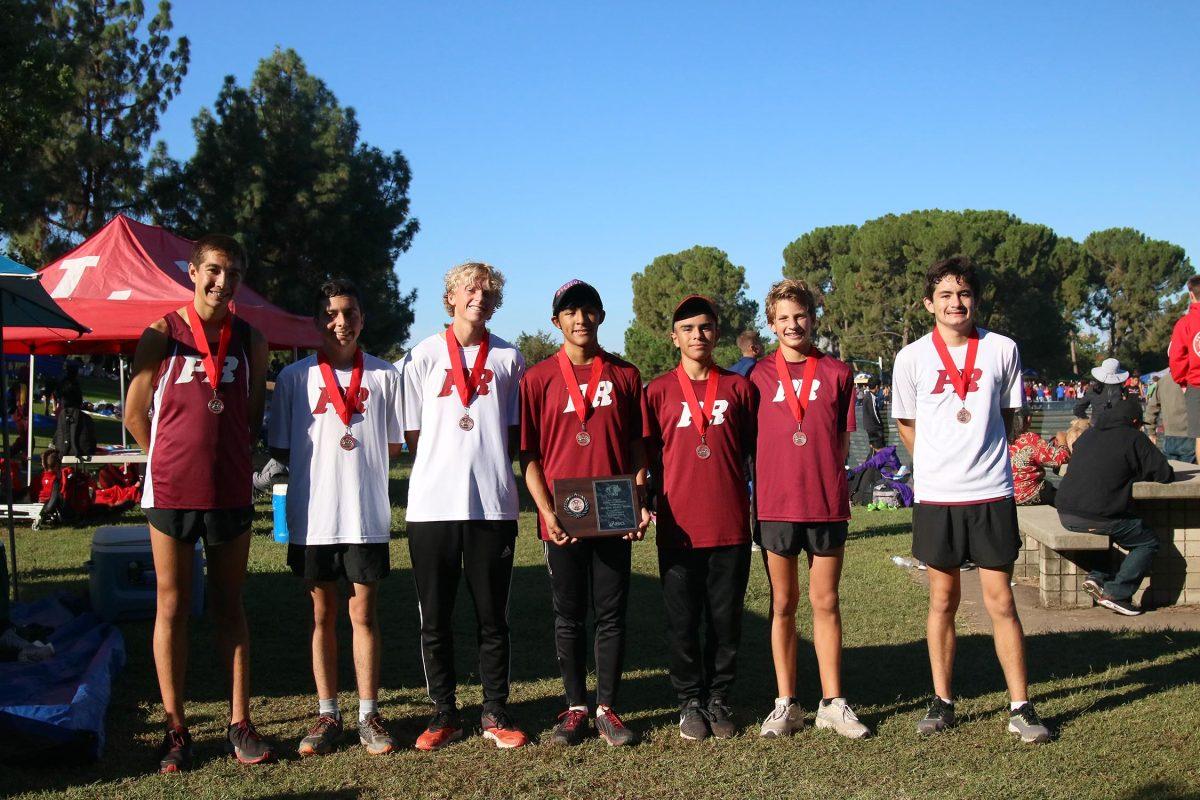 The boys team poses with their plaque and medals, earned by their second place accomplishment. 