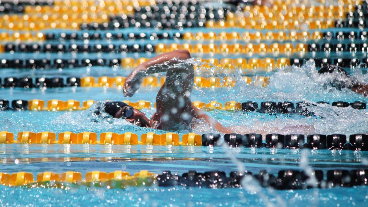 Senior Tre Eade takes a breath as he swims his final lap