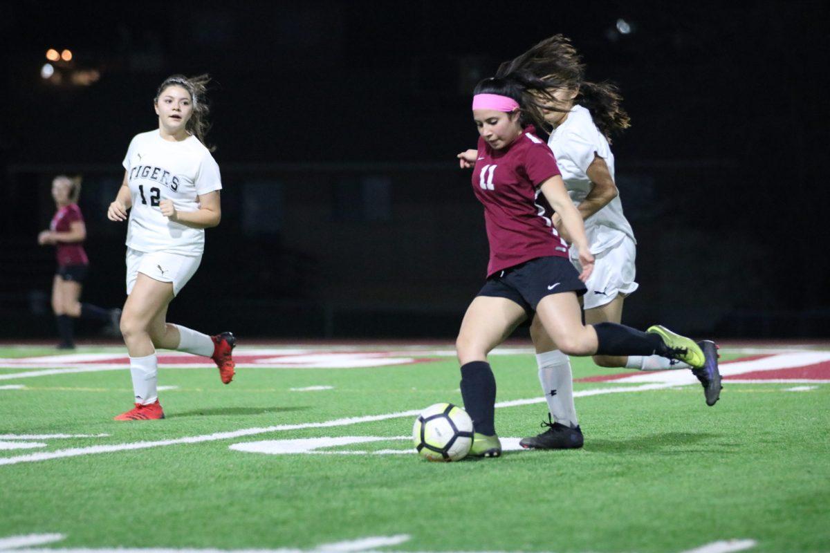 Gaby Verduzco, 9 (#11) opens up her body to pass a through ball to the left wing.