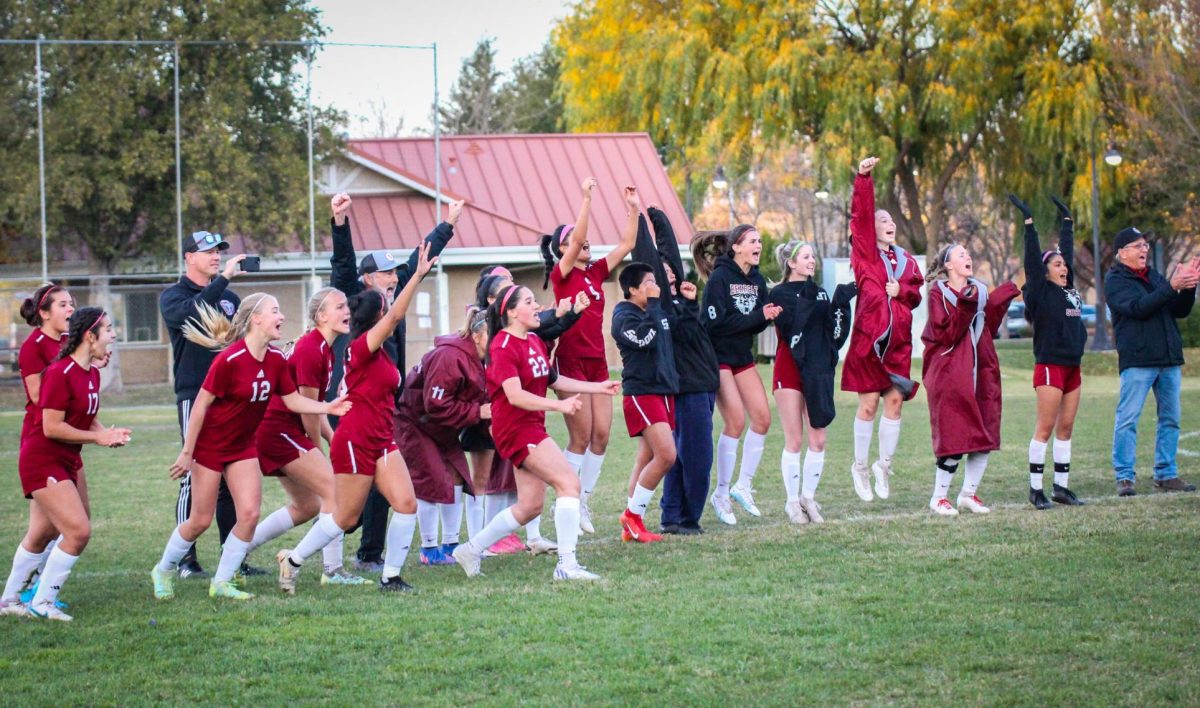 Coaches and team celebrate as the winning penalty is scored by Riley Helberg. 