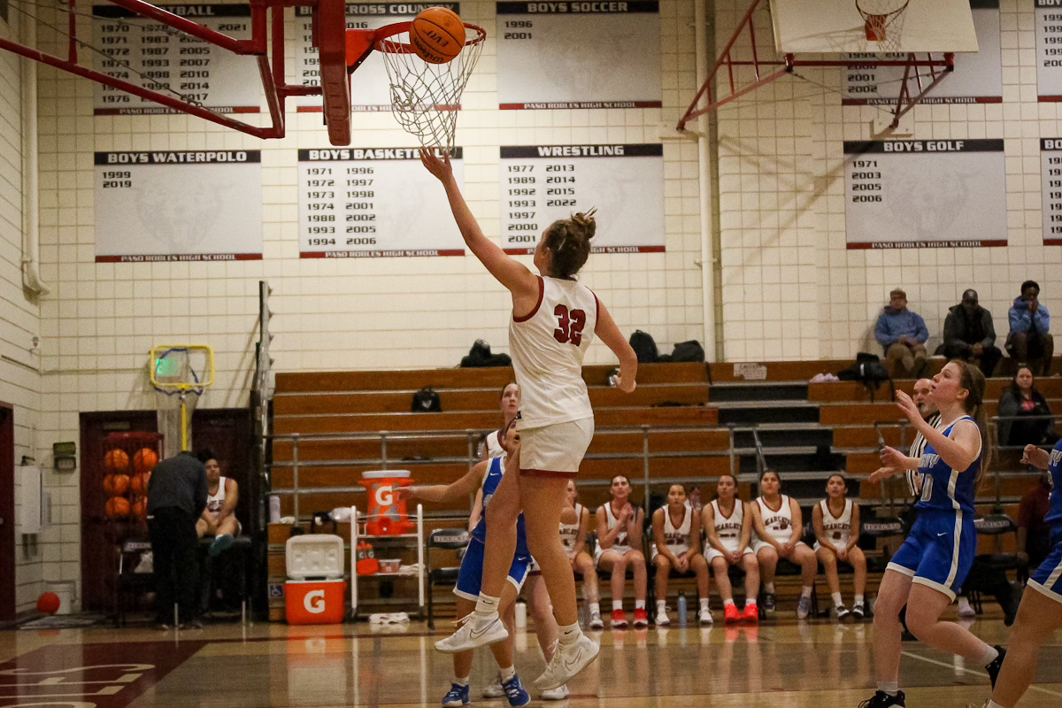 Hoops and Hops: Tori Holbrook, freshman, jumps tipping the ball into the hood, adding points to the Bearcats lead against Kingcity. The only freshman on the varsity team, Holbrook had many points this game. 
