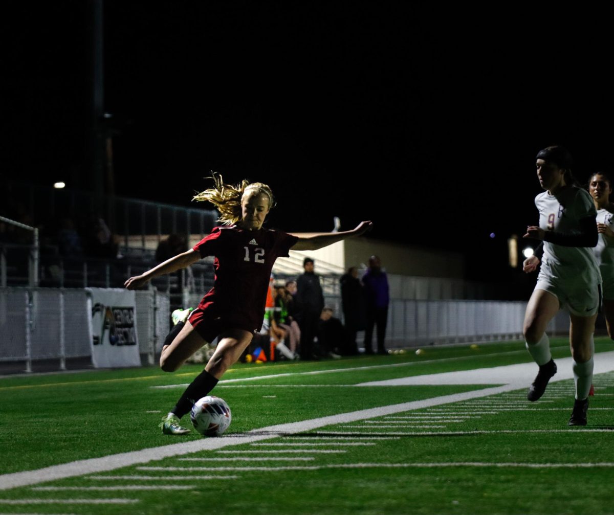 Lila Colegrove, freshman on Girls Varsity Soccer, crosses ball for opportunity at goal. 