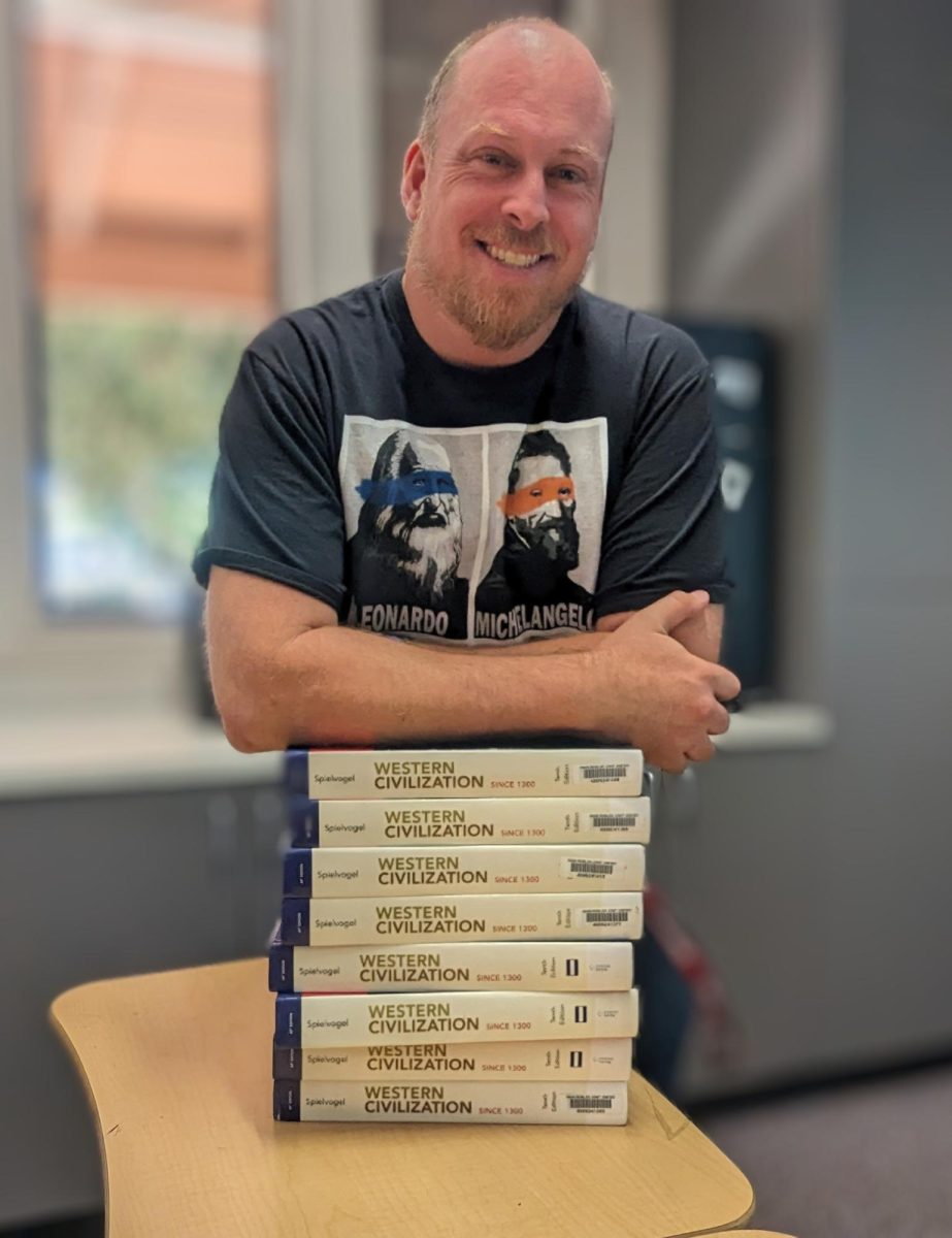 History Teacher Mr. Smith posing on his textbooks!