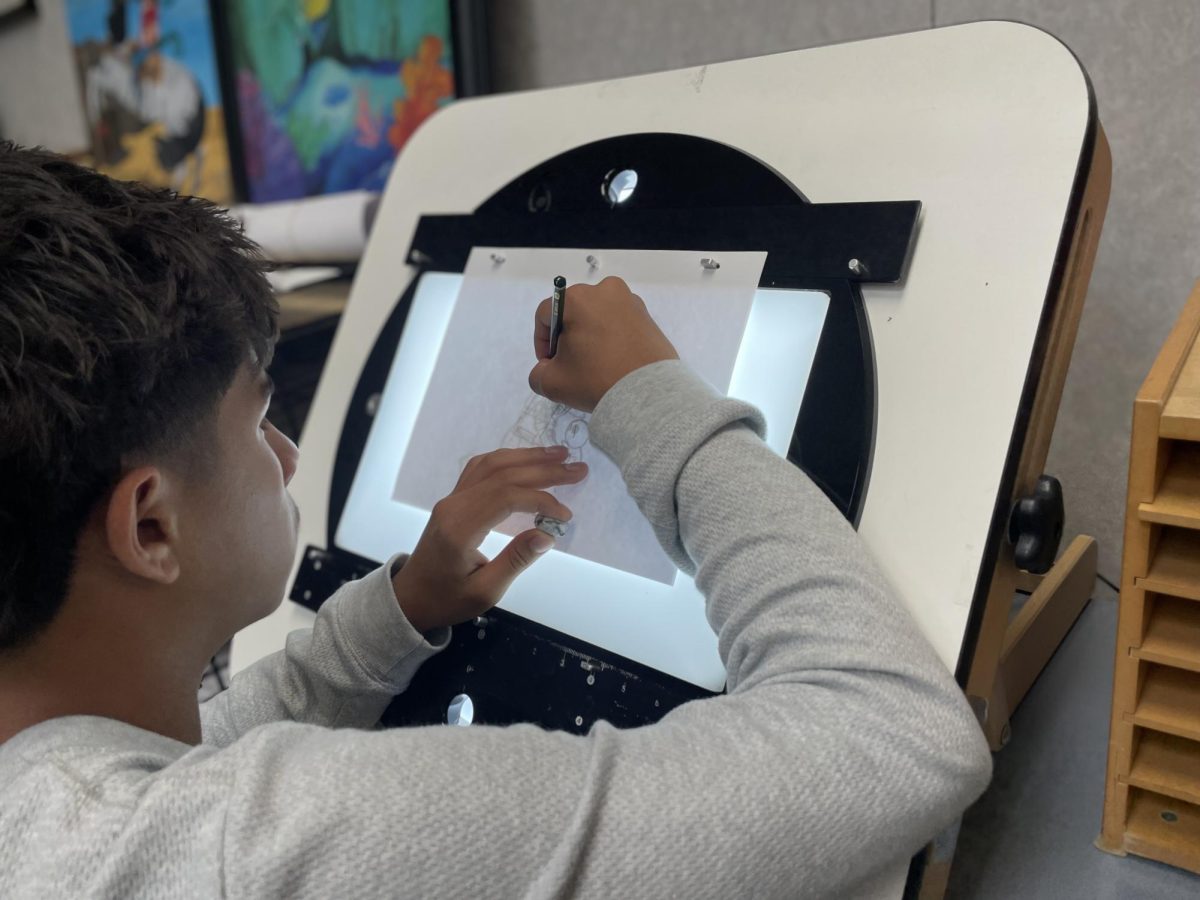 Animation student in first period works on his second animation using a light table.