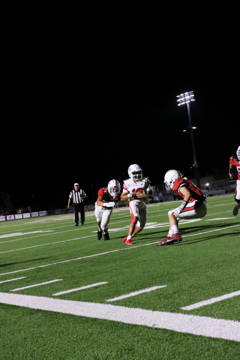 Senior's Matthias Willis (34) and Parker Craig (6) going for a tackle against Senior Joshua Madrigal (12)