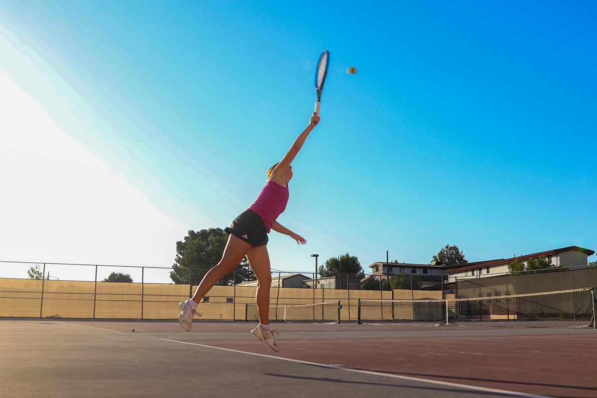 Tennis captain Smith crushes a second set serve in the September 14 game against Templeton HS. Smith has played varsity since ninth grade,