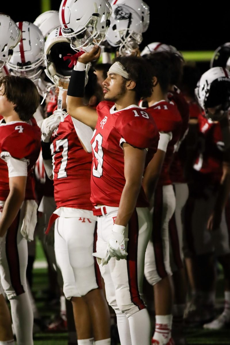 Junior Jayden Cross lifts his helmet to the sky to thank the fans after a game against Madera September 12, 2024.