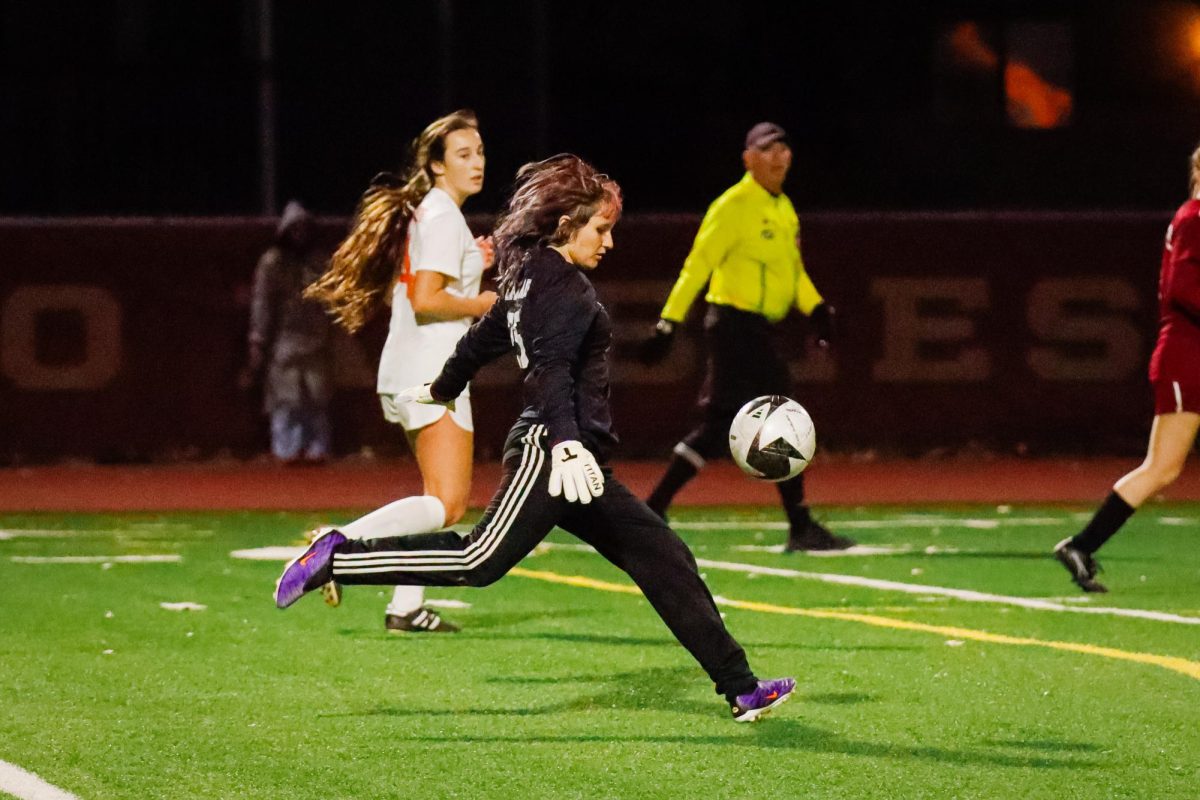 Sophomore Sunset Makarow-Sanchez drop kicks the ball to clear it from their half