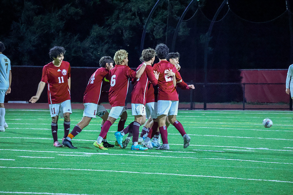 Boys varsity soccer celebrates a goal by sophomore Isaac Jimenez.