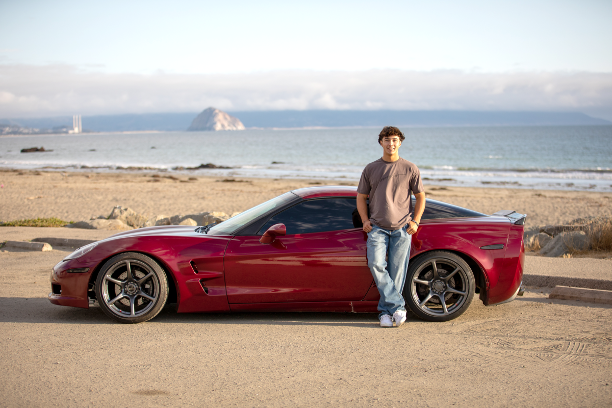 Casa poses in front of his Chevrolet Corvette, which he acquired through his trade of flipping vehicles last year.