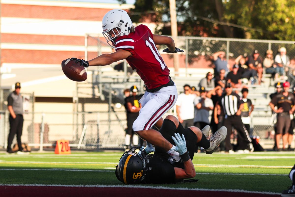 Junior Emmett Dobroth stretches out for the endzone after making a catch over a SLO defender.