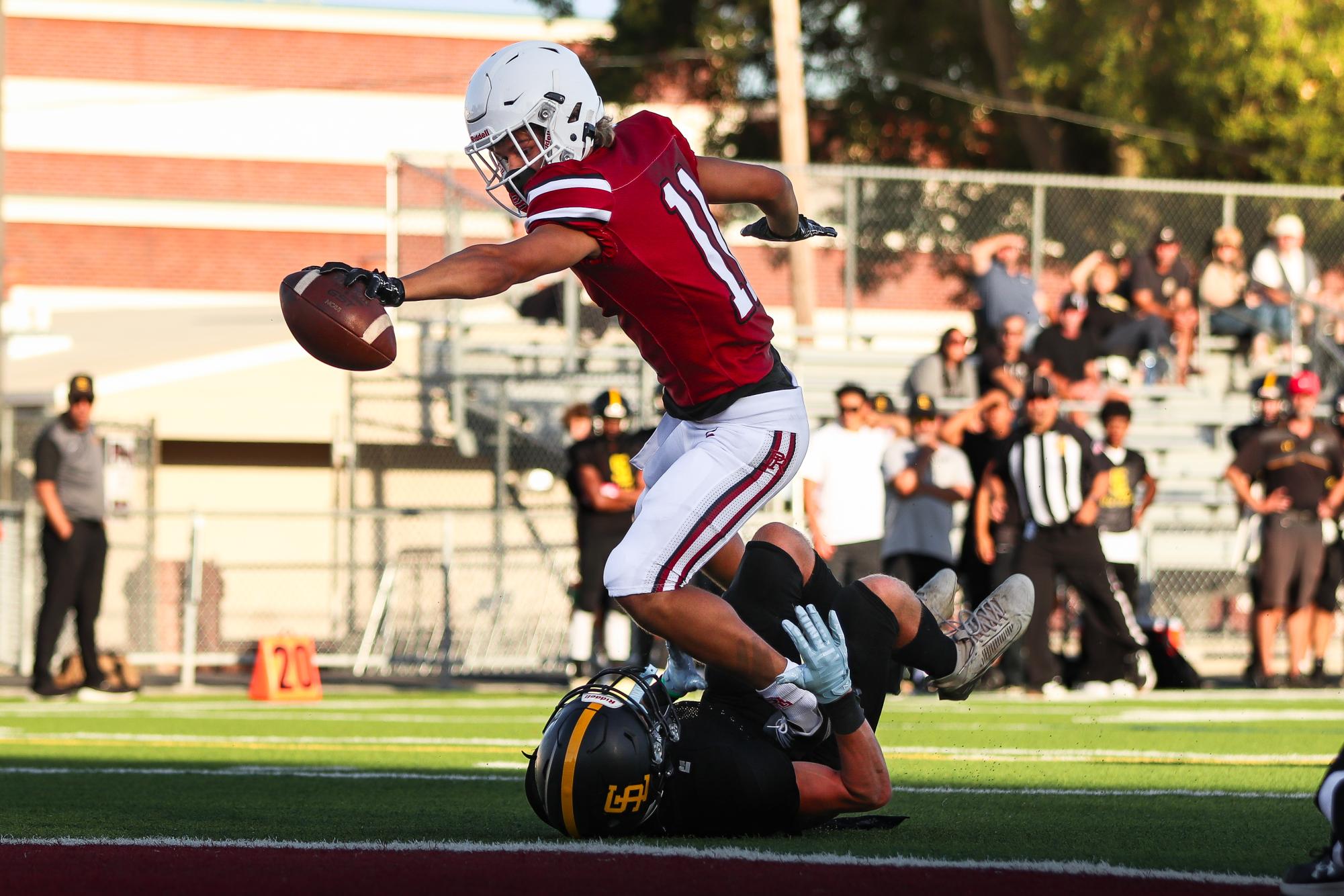 Junior Emmett Dobroth stretches out for the endzone after making a catch over a SLO defender.