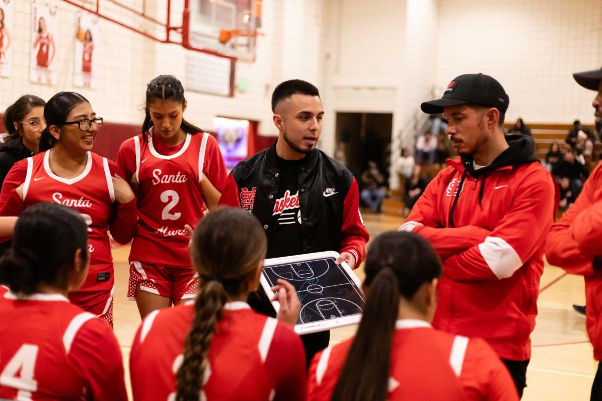 FOCUS - As Santa Maria falls behind, head coach Erik Ramos-Razo outlines areas for improvement during a timeout.